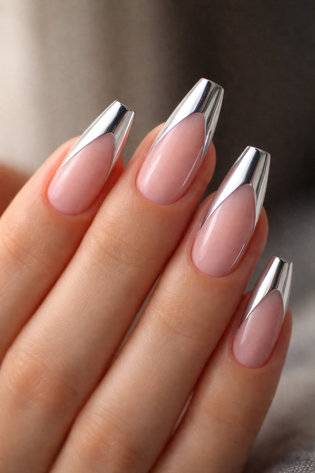 Nude-based ballerina nail with a silver diagonal side-French tip.