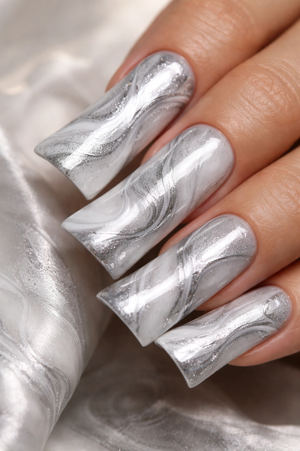 Duck nail with silver and white marble swirl pattern.