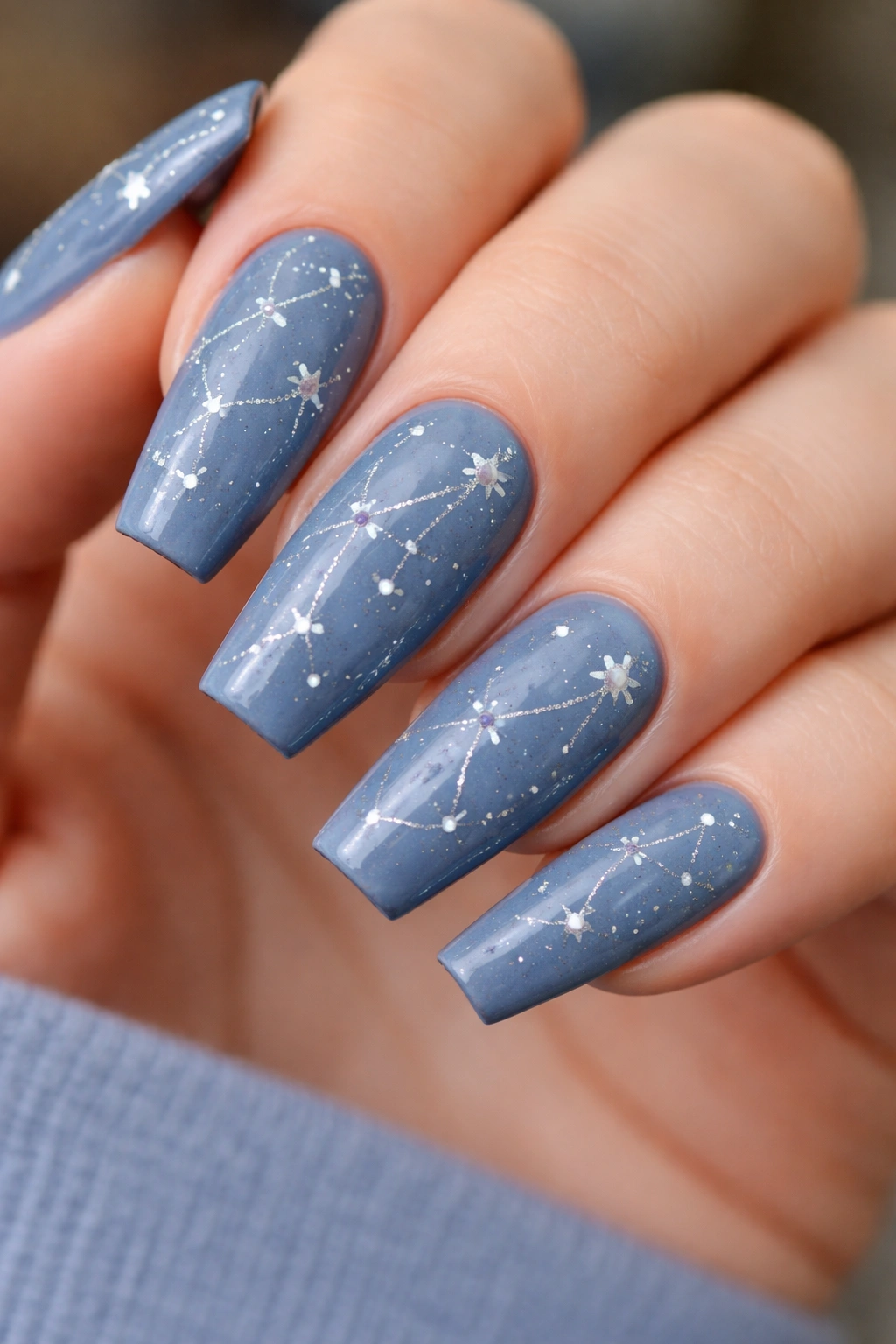 Slate blue nails with constellation star pattern.
