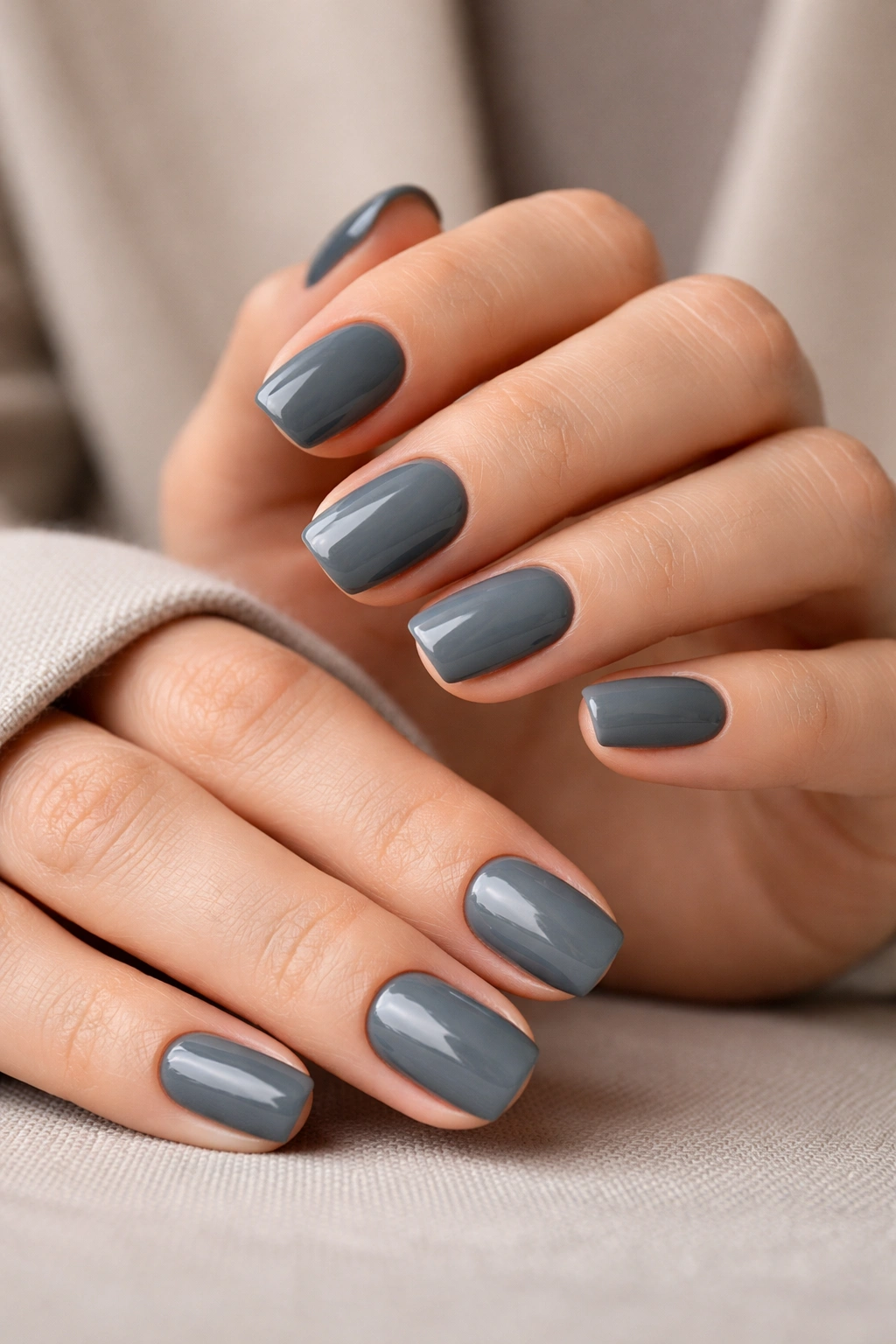 Close-up of slate gray squoval nails in a professional style.