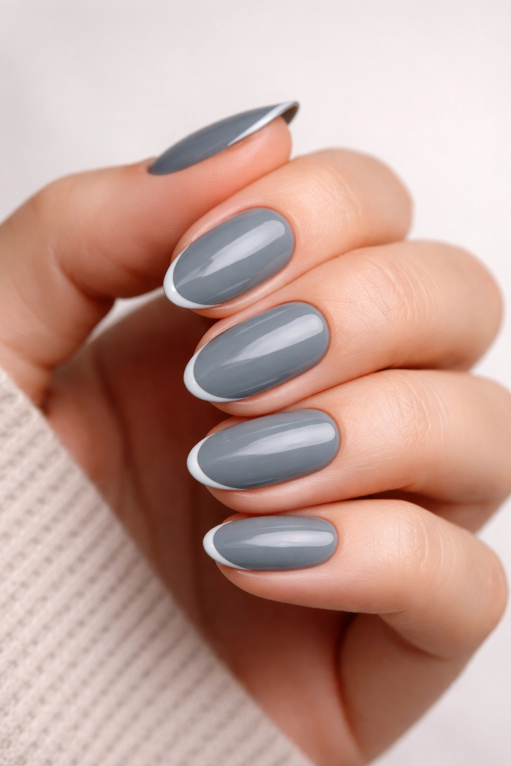 Short almond nails with slate grey base and a thin micro French line