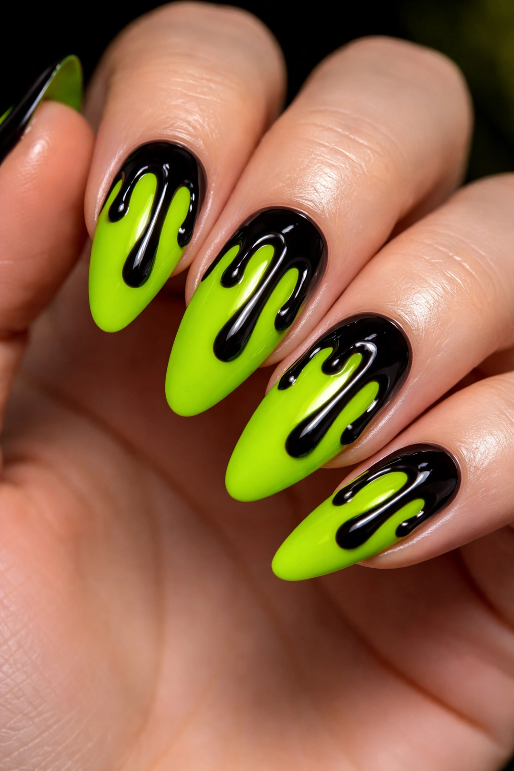 Almond nails with neon green slime and black drips.