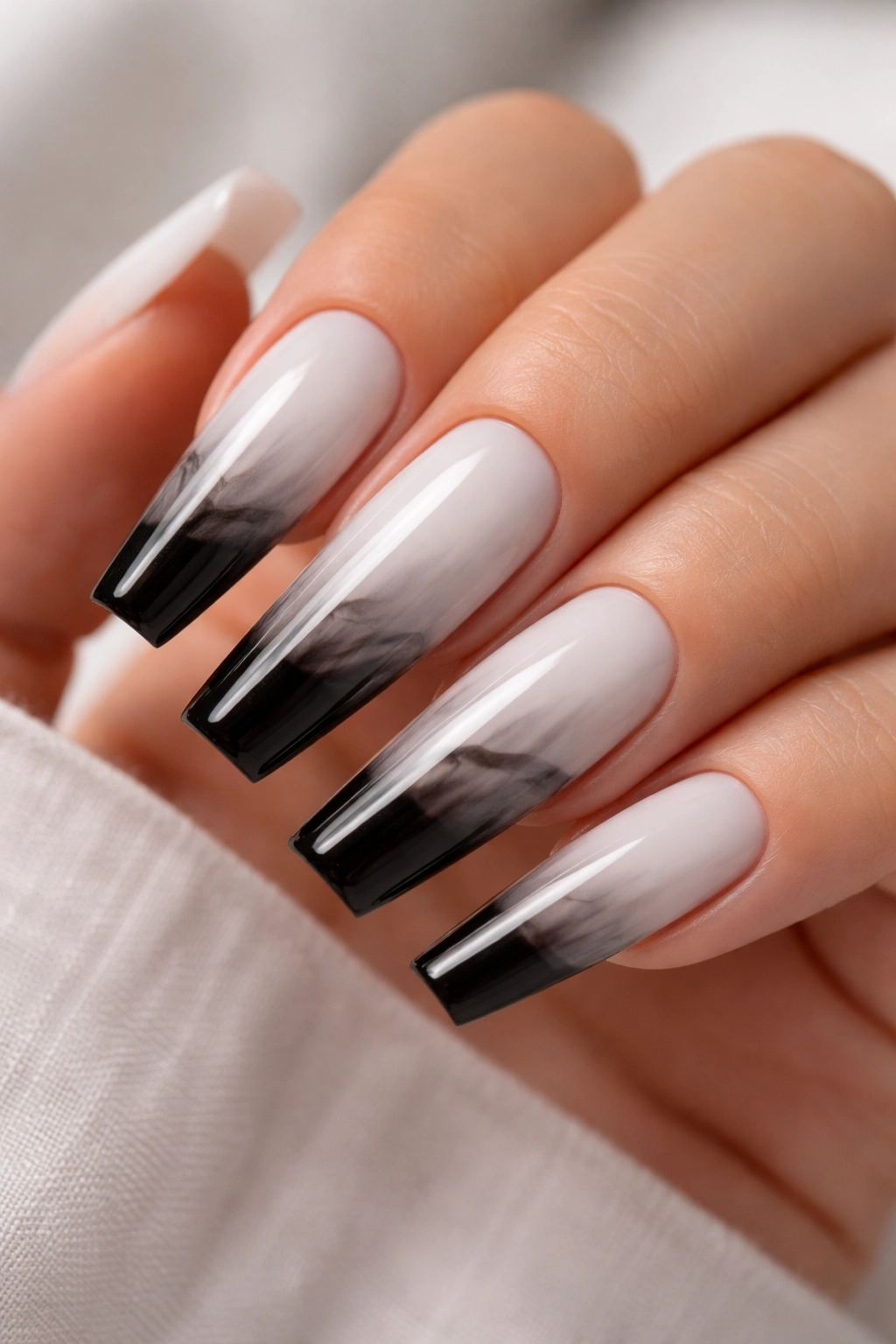 Close-up of long ballerina nails with a mixed-finish black-and-white smoke ombré fade