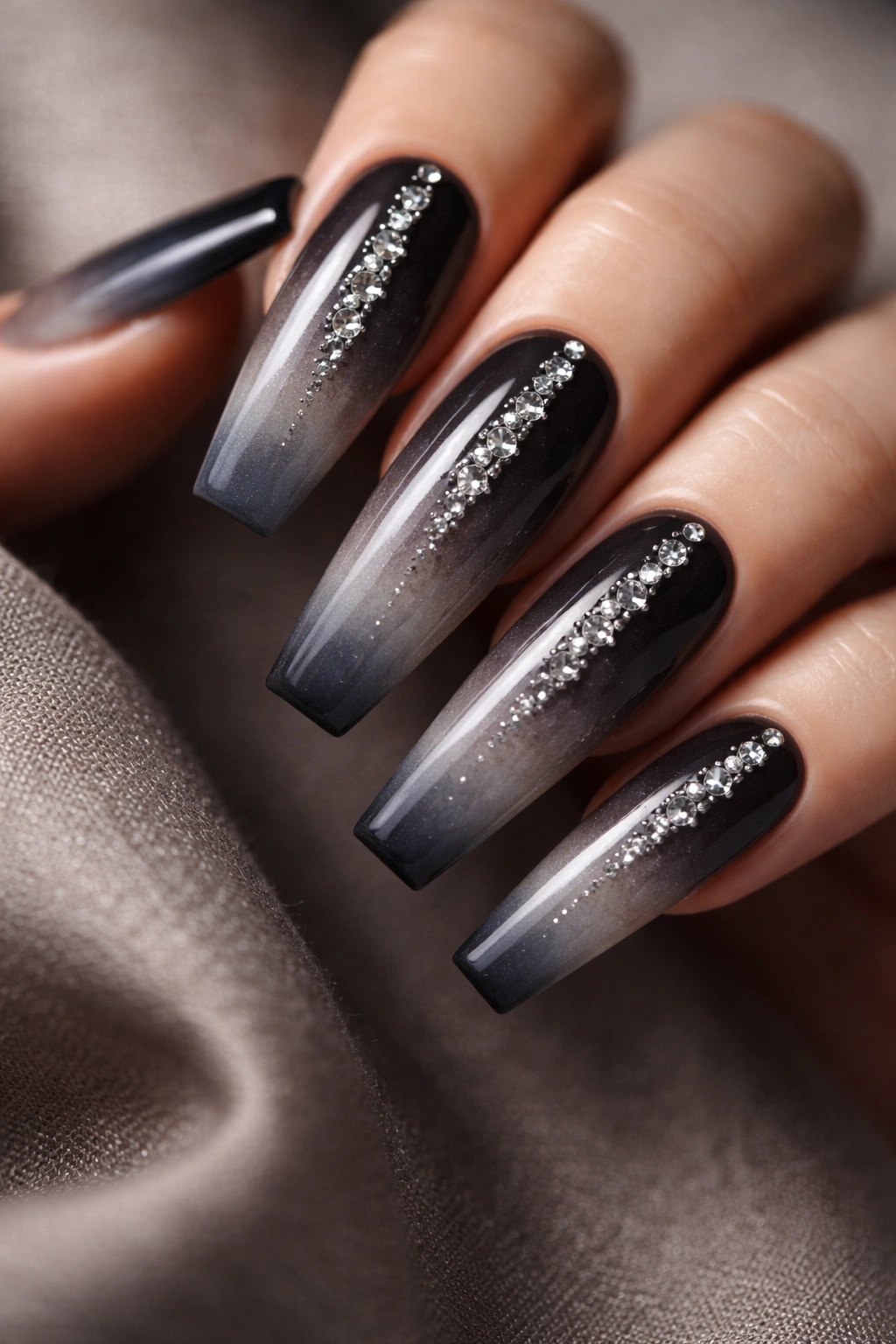 Moody coffin nails with charcoal to gray gradient and rhinestone accents