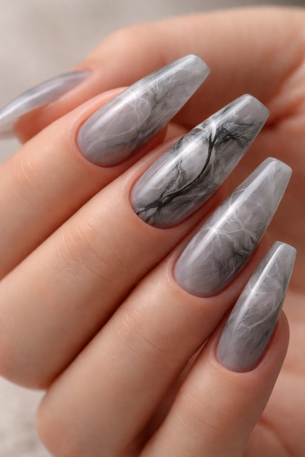 Close-up of smoky gray marble ballerina nails with wispy veining