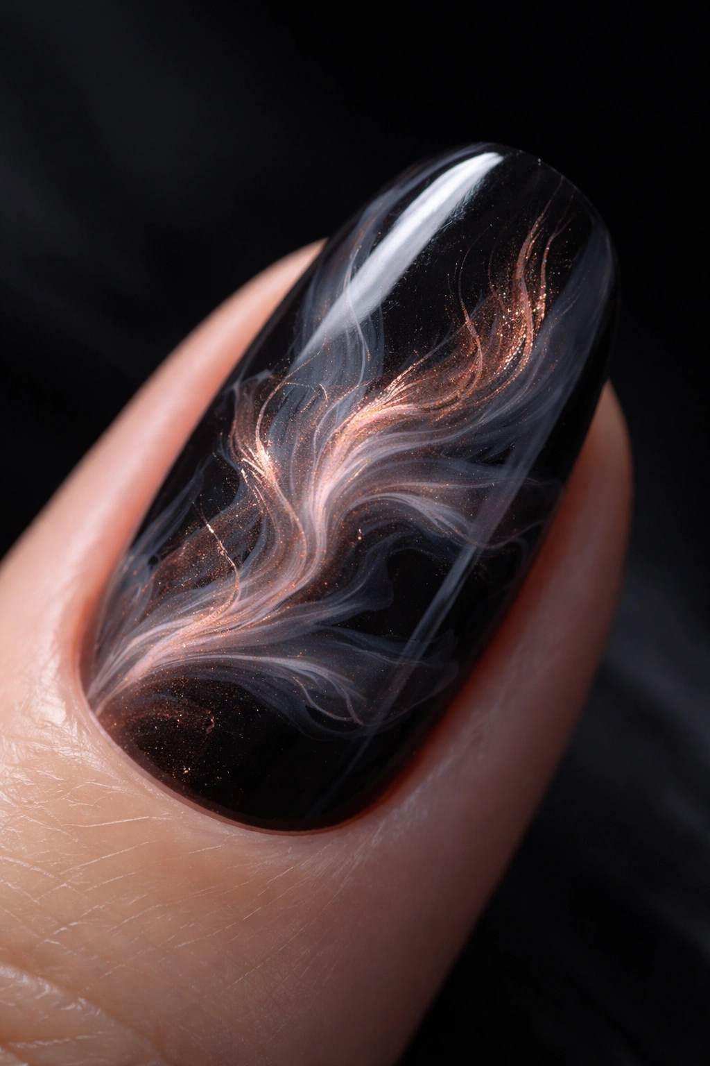 Close-up of a smoky blooming gel nail on a dark base with wispy lines
