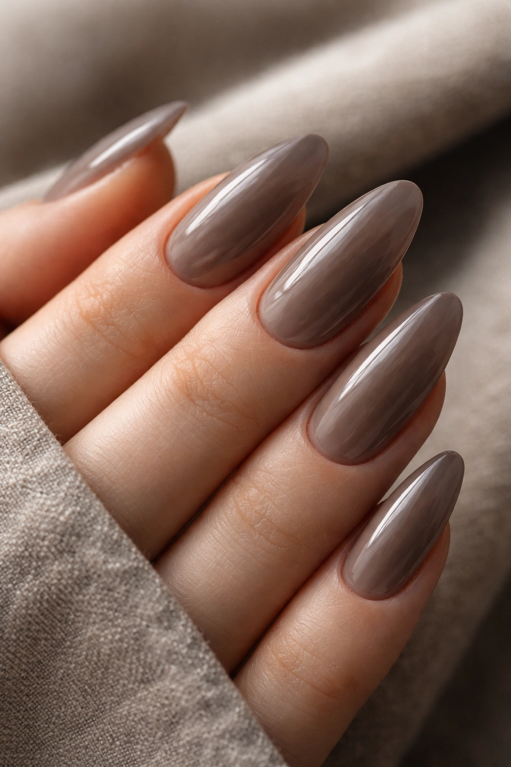 Smoky nude almond nails with gray-brown tones
