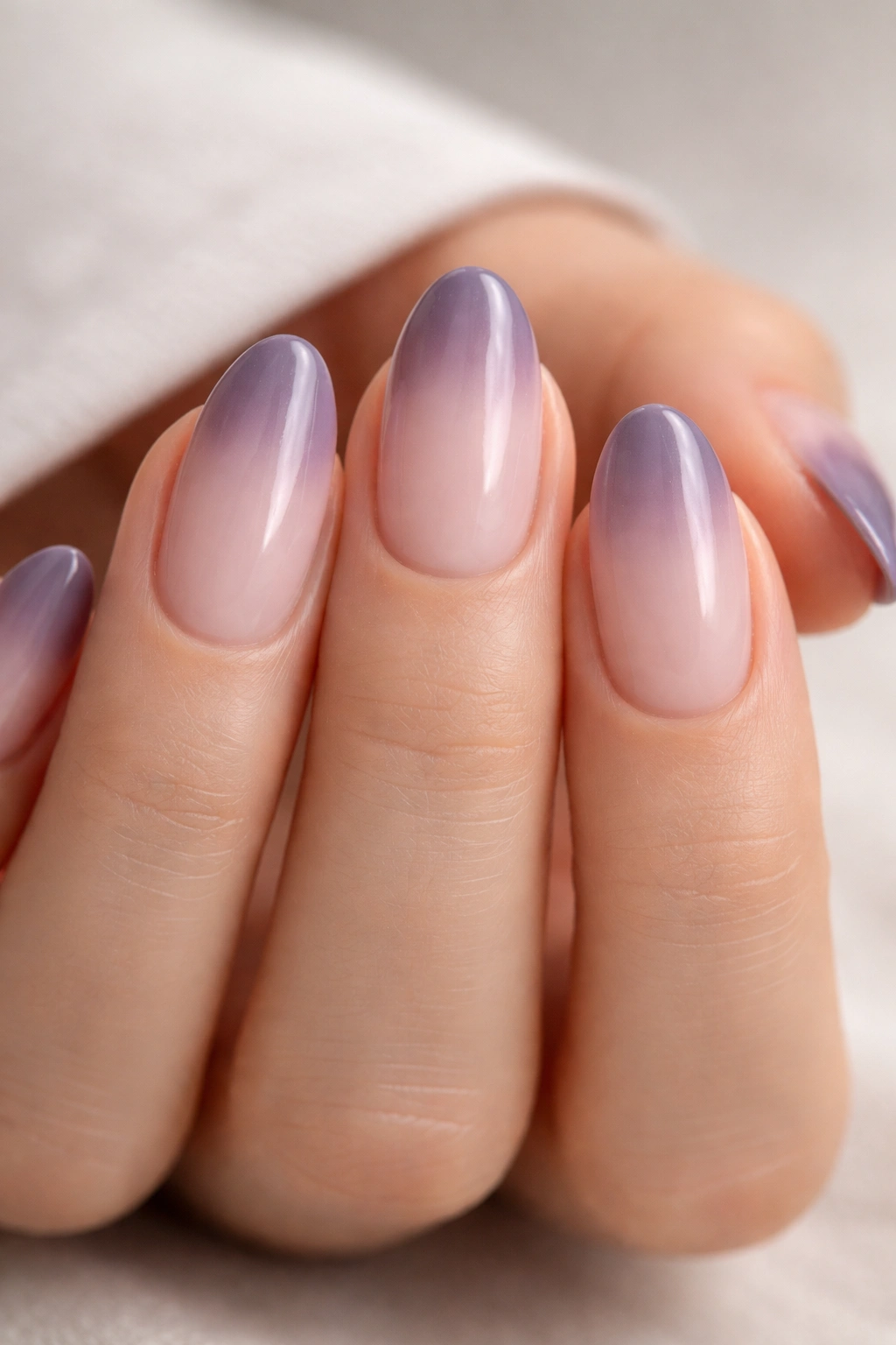 Smoky purple fade nails on short almond nails with soft gradient