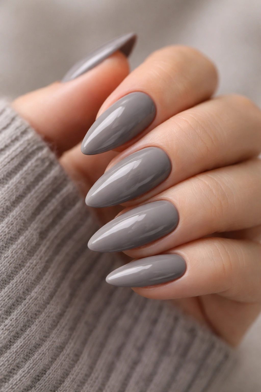 Close-up of smoky taupe almond nails with cool undertone and finish