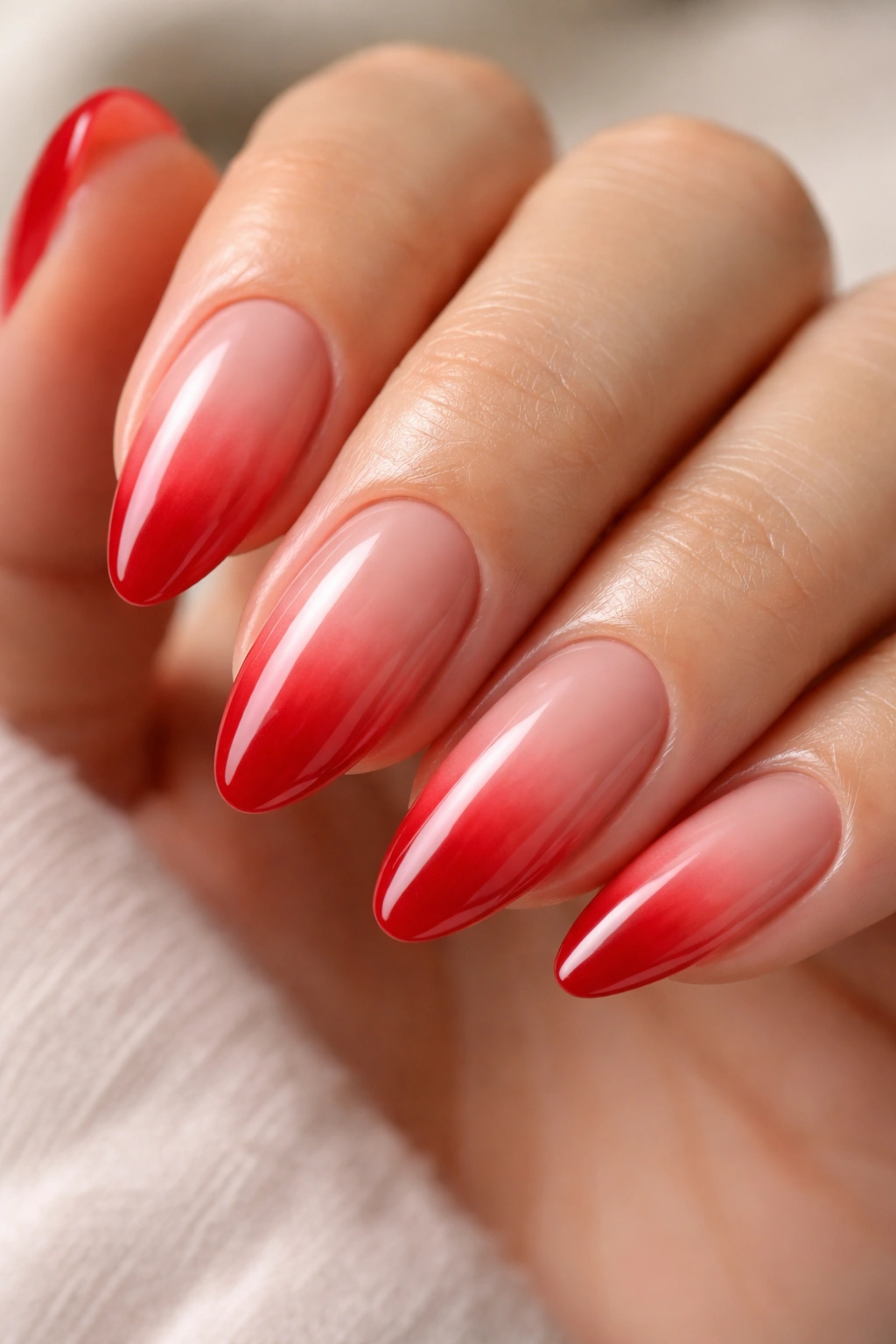 Almond nails with smooth nude-to-red ombre gradient