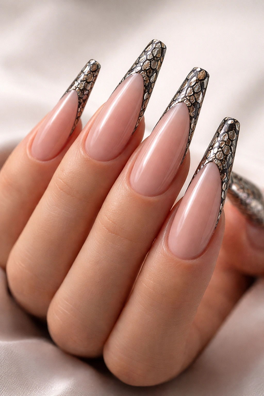Close-up of long acrylic nails with a two-tone snake skin edge pattern in black and white.