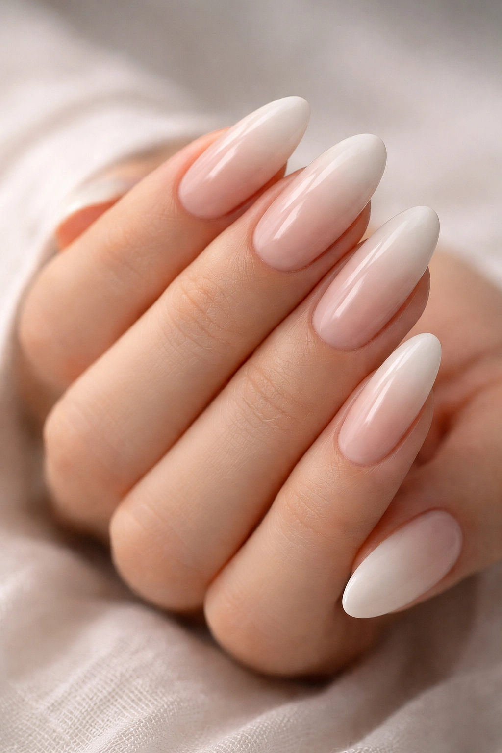 Close-up of long oval nails with soft baby boomer fade