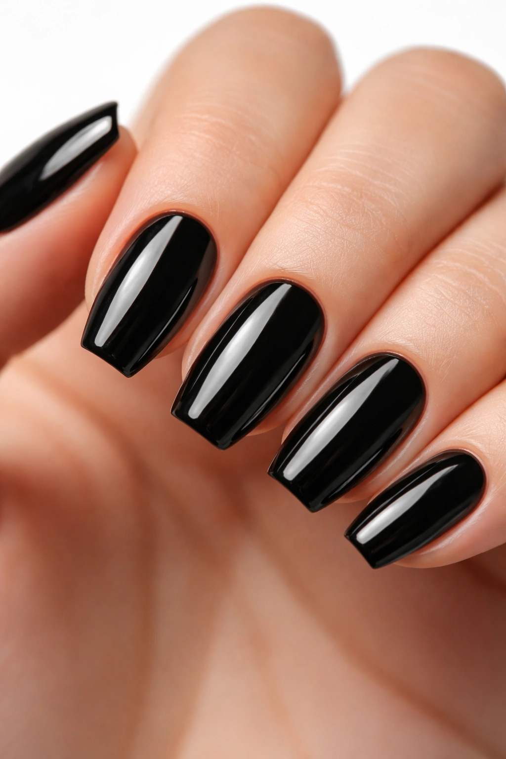 Close-up of glossy black short ballerina nails with crisp taper