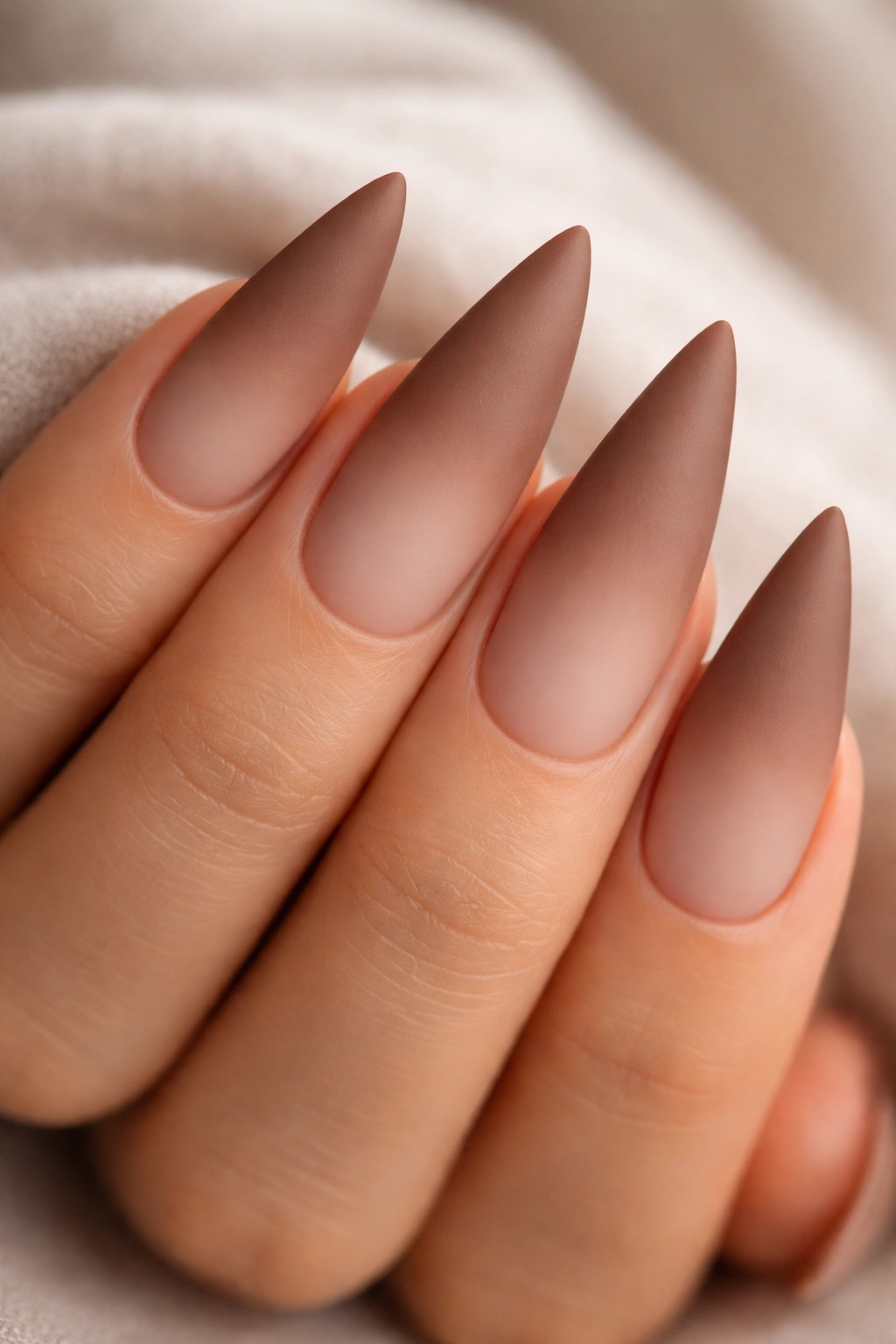 Matte finish soft brown to nude ombre stiletto nails