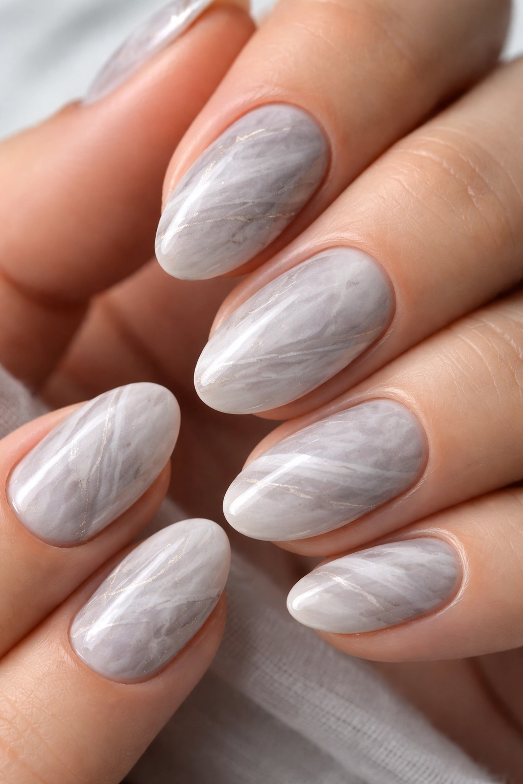 Short almond nails with cool-tone layered gray marble
