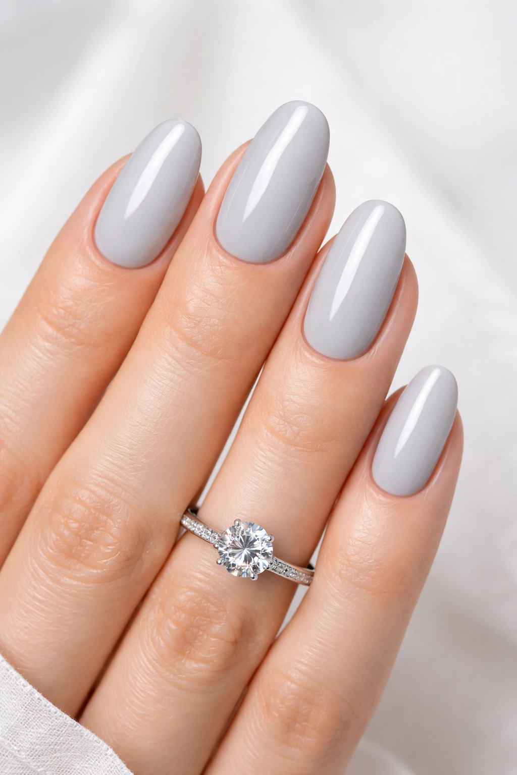 Close-up of soft gray nails with cool-toned polish