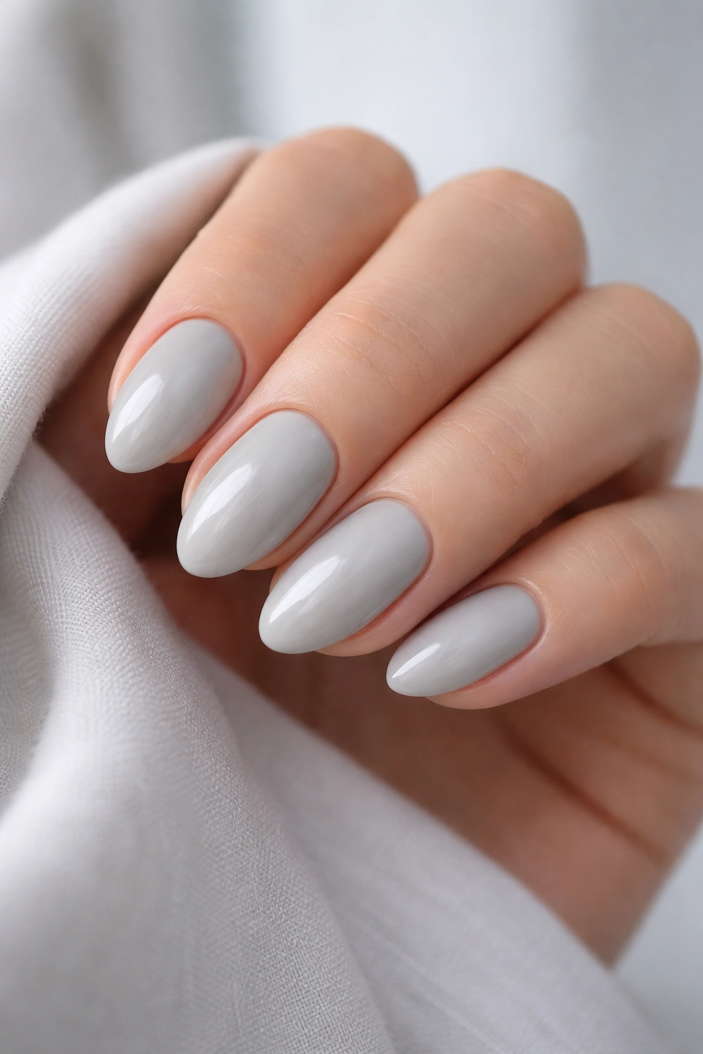 Close-up of soft gray almond nails on short nails