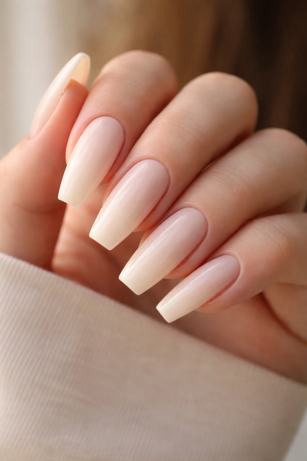 Close-up of soft ivory ballerina nails with creamy base