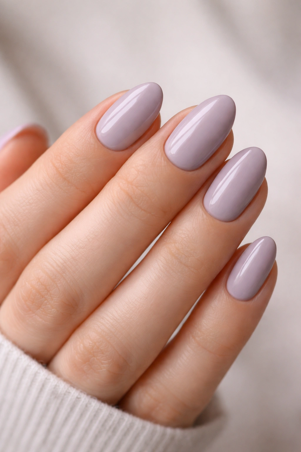 Close-up of soft lavender short almond nails with creamy finish