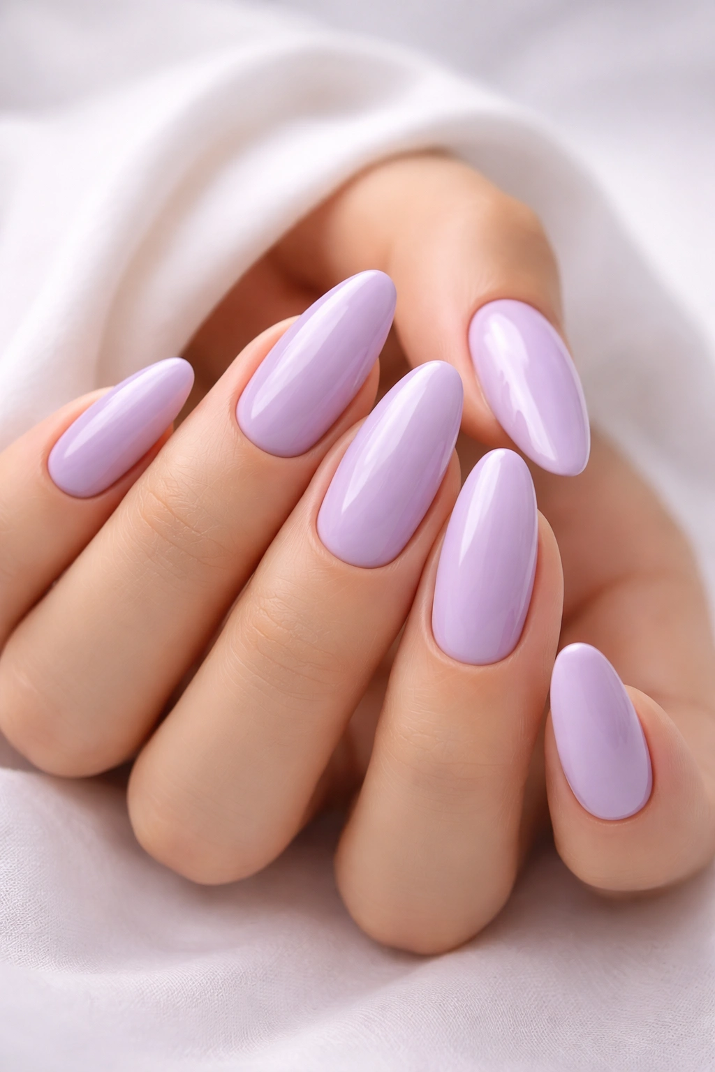 Close-up of soft lavender nails on a hand with solid lavender manicure