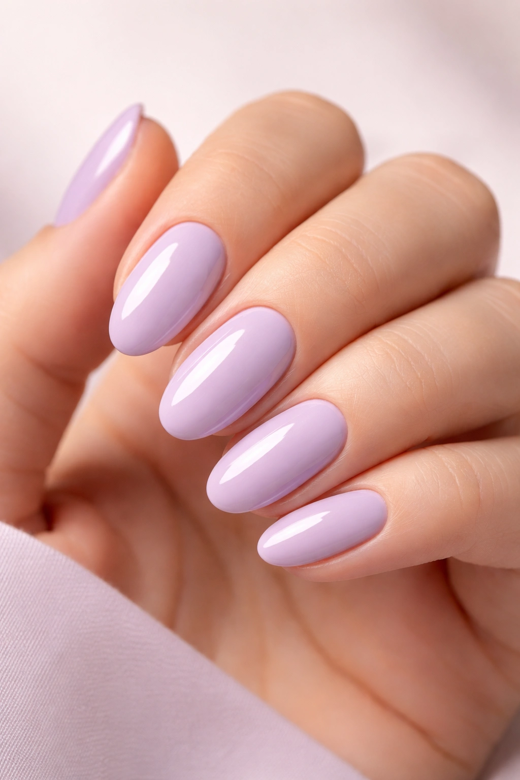 Oval nails painted soft lavender with glossy finish