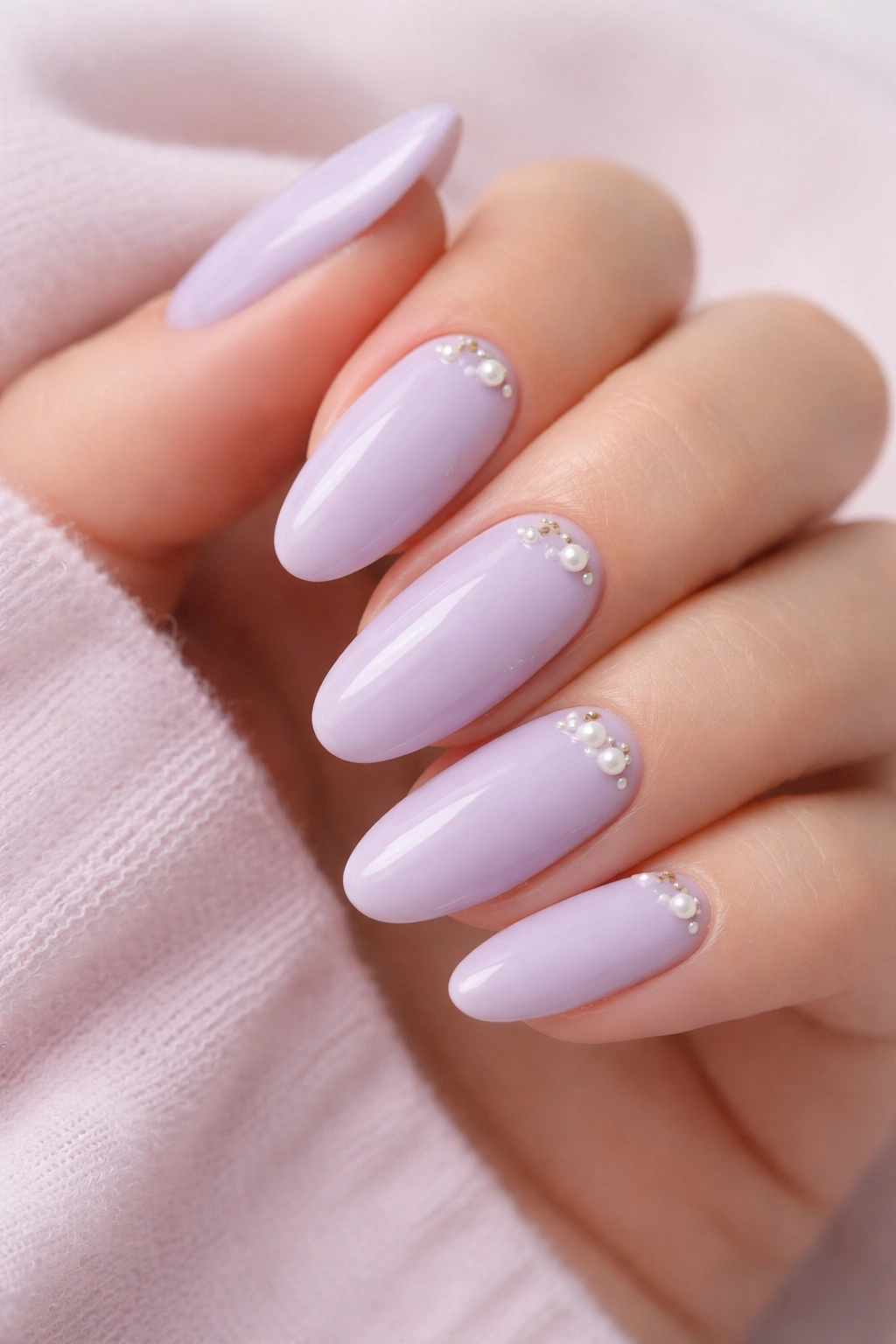 Soft lilac nails with pearl accents near the cuticle