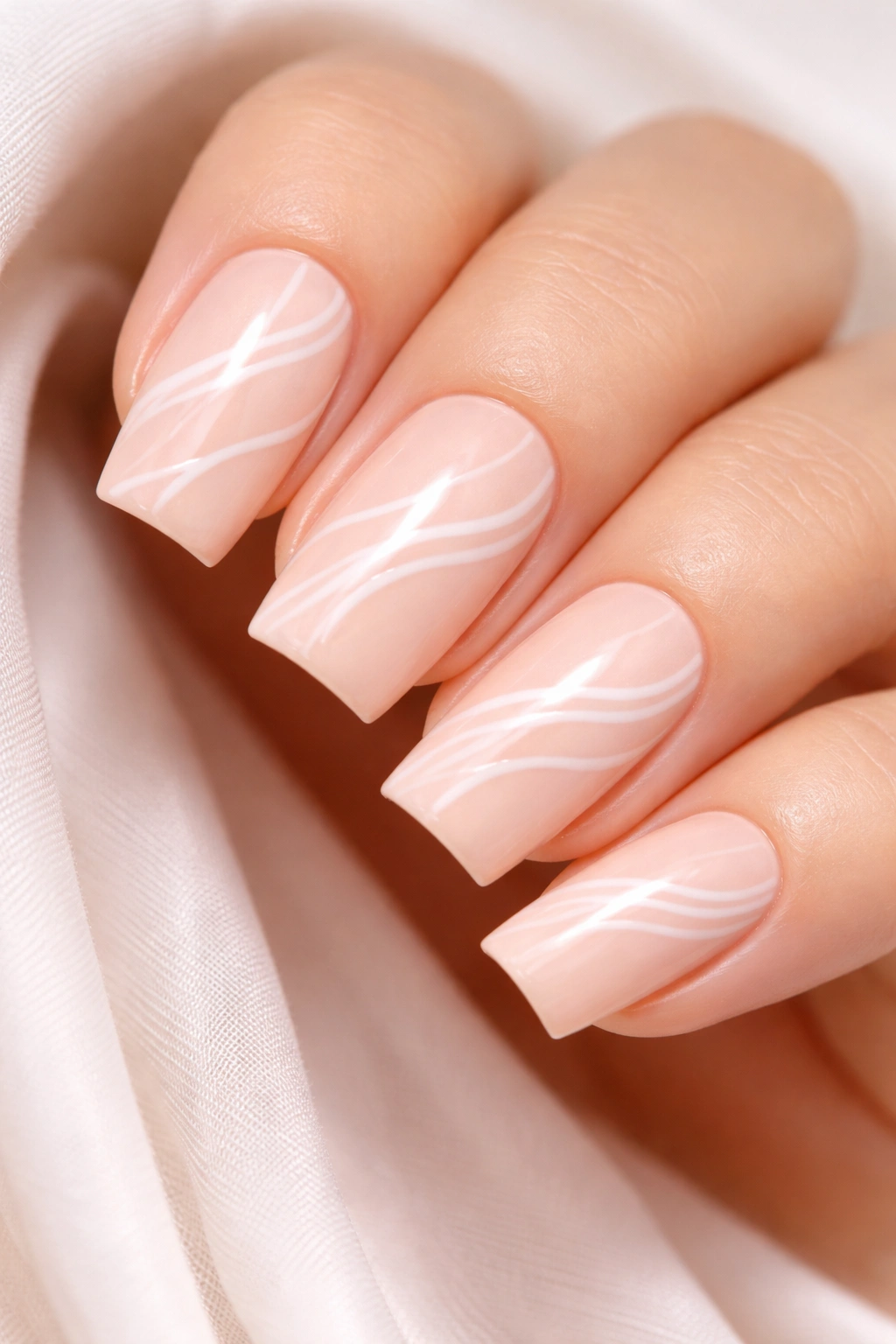 Soft peach nails with white wavy lines