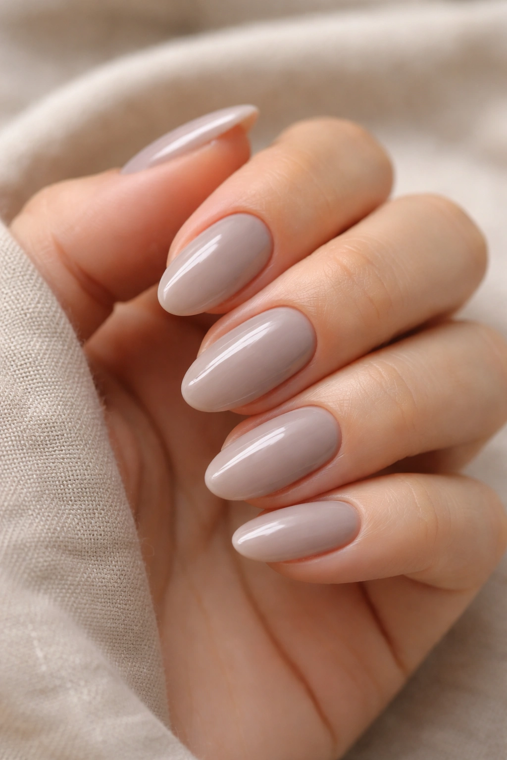 Close-up of soft taupe almond nails with cooler nude tone