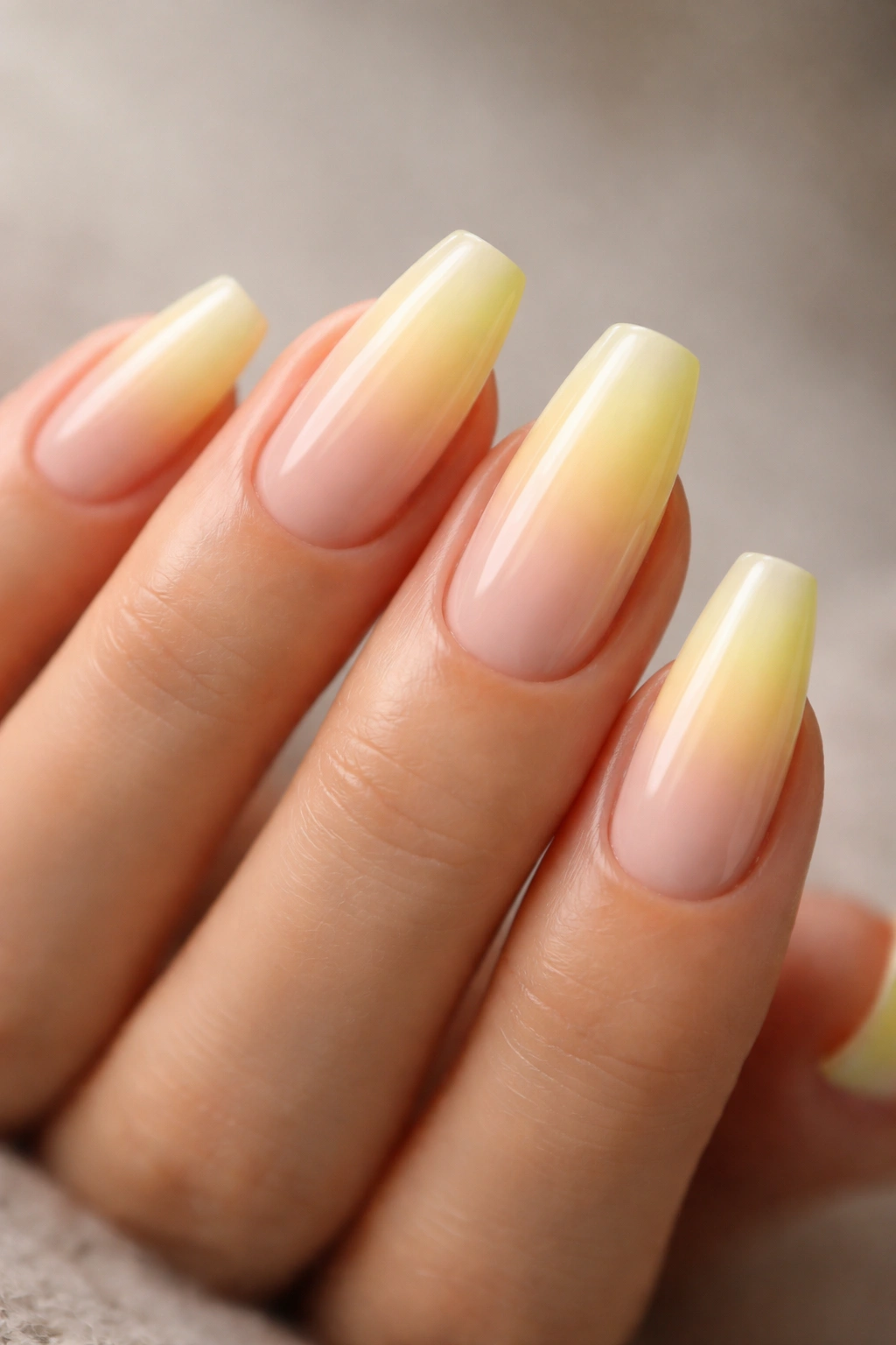 Soft yellow aura fade on nude-base ballerina nails