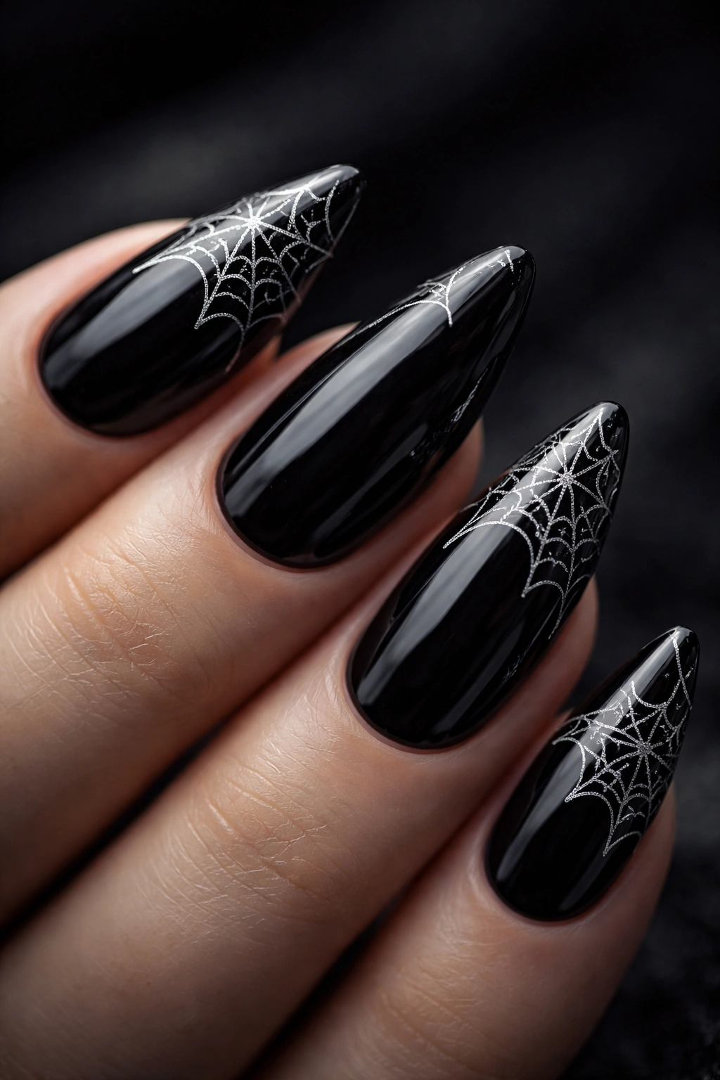 Nails with white spider web pattern in the corner on black base