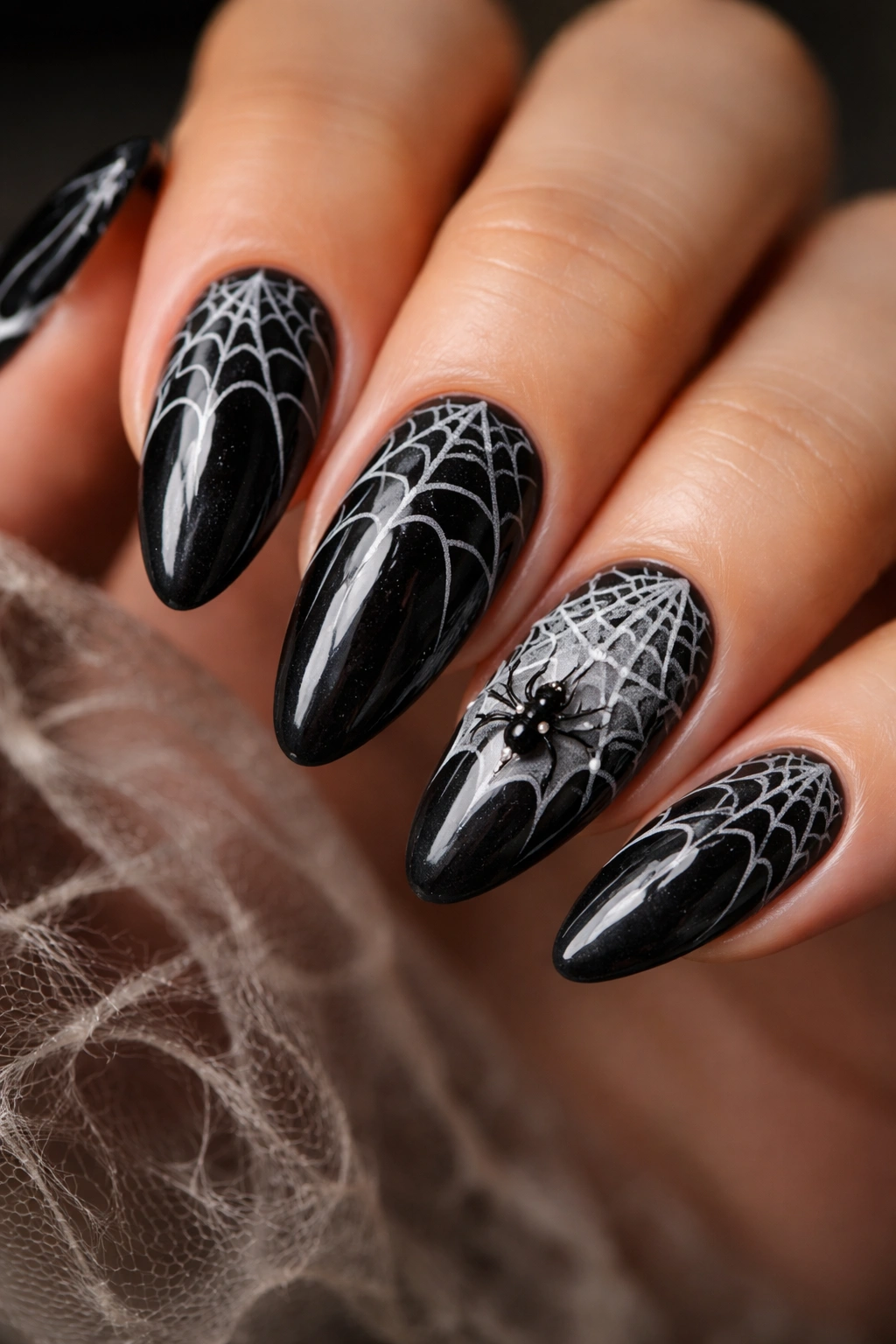 Almond nails with dark base and intricate spider web patterns