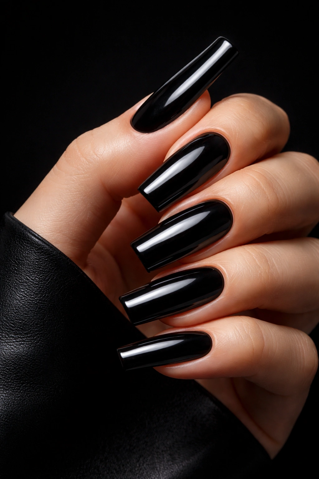 Glossy black square acrylic nails on a hand