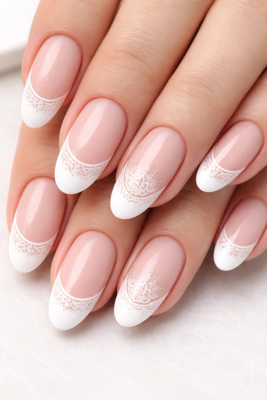 Oval nails with white tips featuring stamped floral patterns