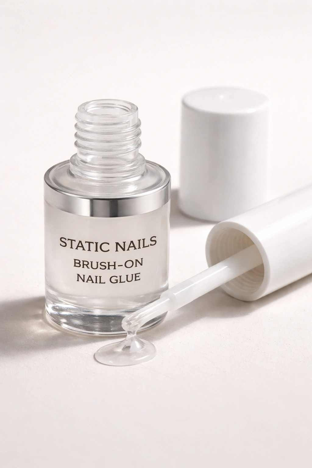 Nail glue bottle with built-in brush applicator