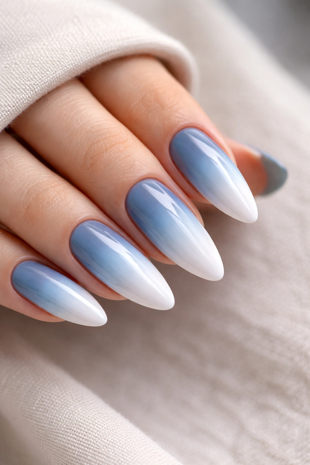 Almond nails gradient steel blue to white, close-up manicure