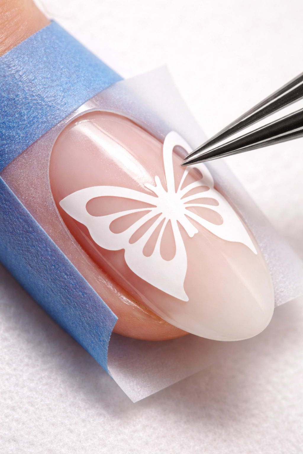 Nail with stencil applied for precise airbrush design.