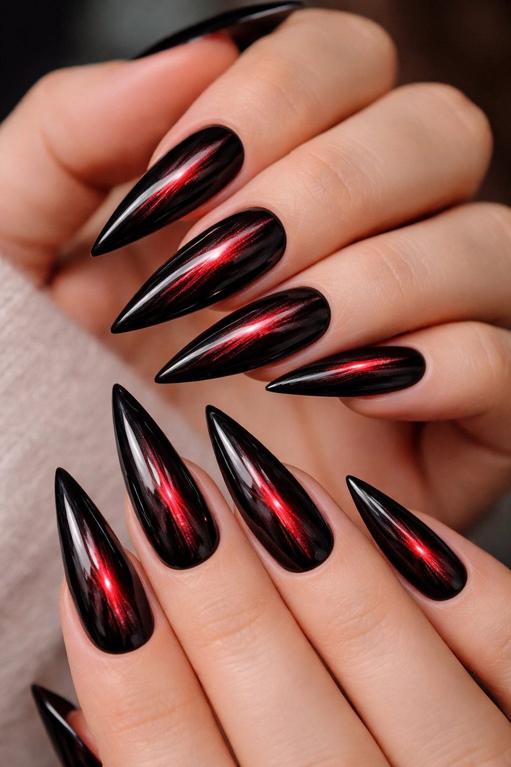 Stiletto nails with red cat-eye line on black base