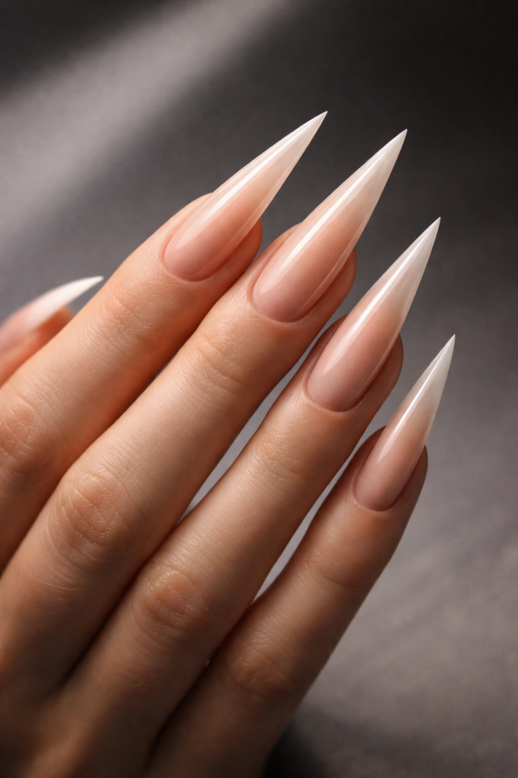 Close-up of a hand with long, pointed stiletto nails