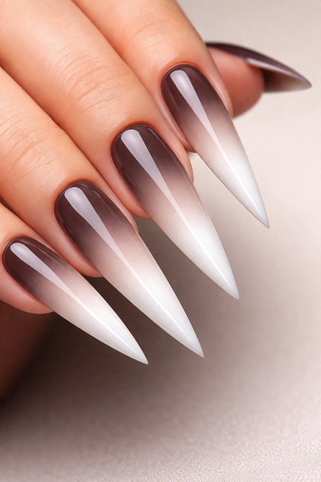 Stiletto nails with a black-to-white ombré gradient