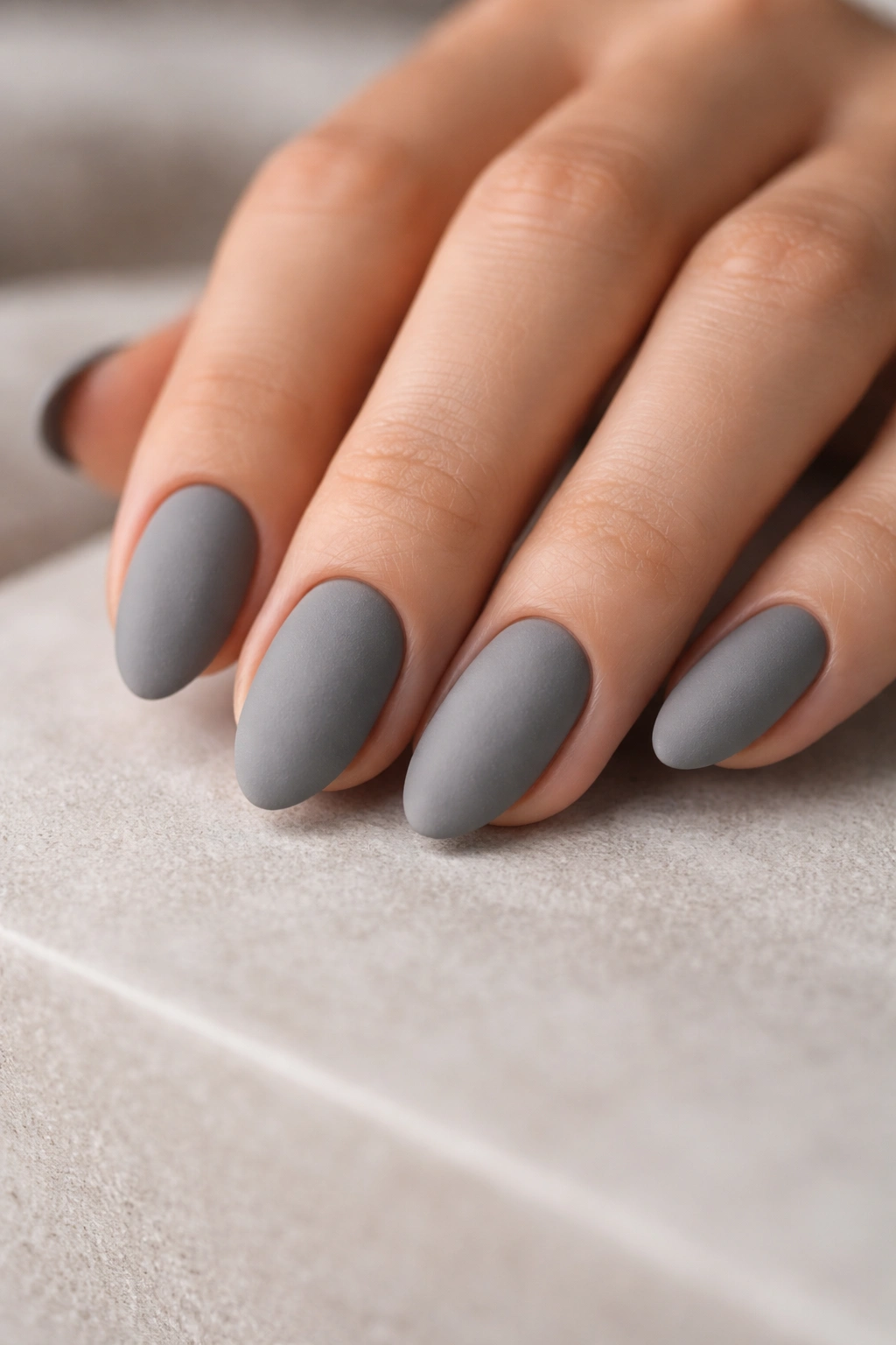 Matte stone gray short almond nails on hand