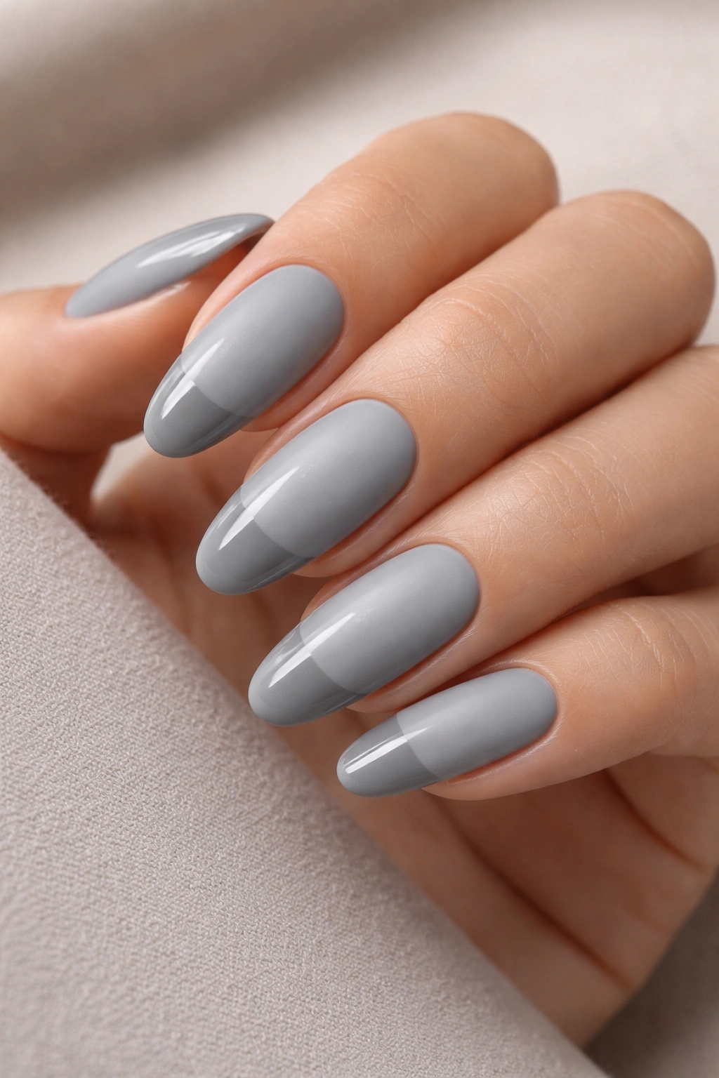 Close-up of stone grey oval nails showing matte base and glossy tips