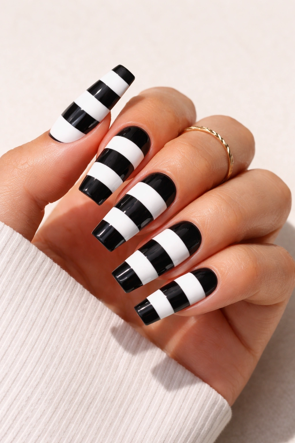 Close-up of coffin nails with bold horizontal black and white stripes