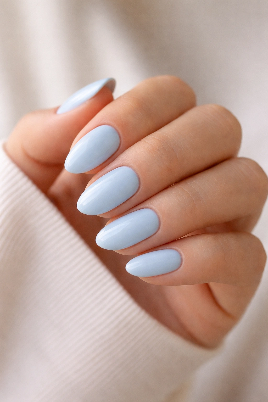 Short almond nails painted light blue with a simple polished style