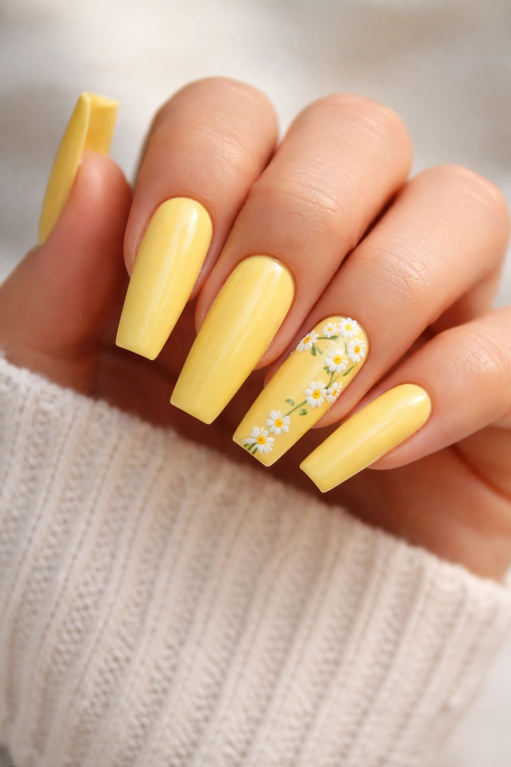 Bright yellow coffin nails with tiny white daisies on accent nails