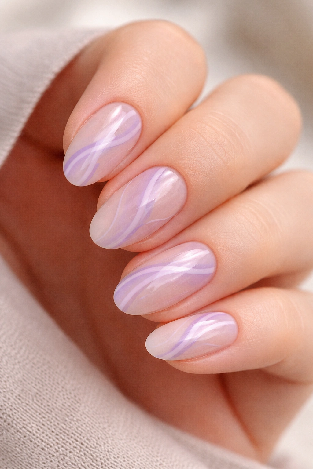 Short almond nails with lavender and lilac swirl design