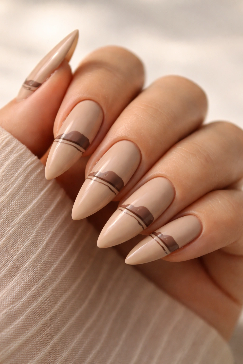 Tan stiletto nails with minimalist landscape line art