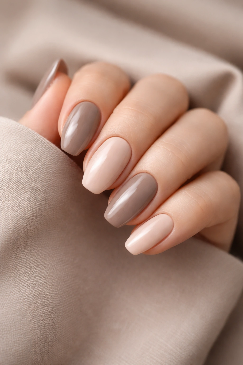 Close-up of taupe and beige manicure on fingertips