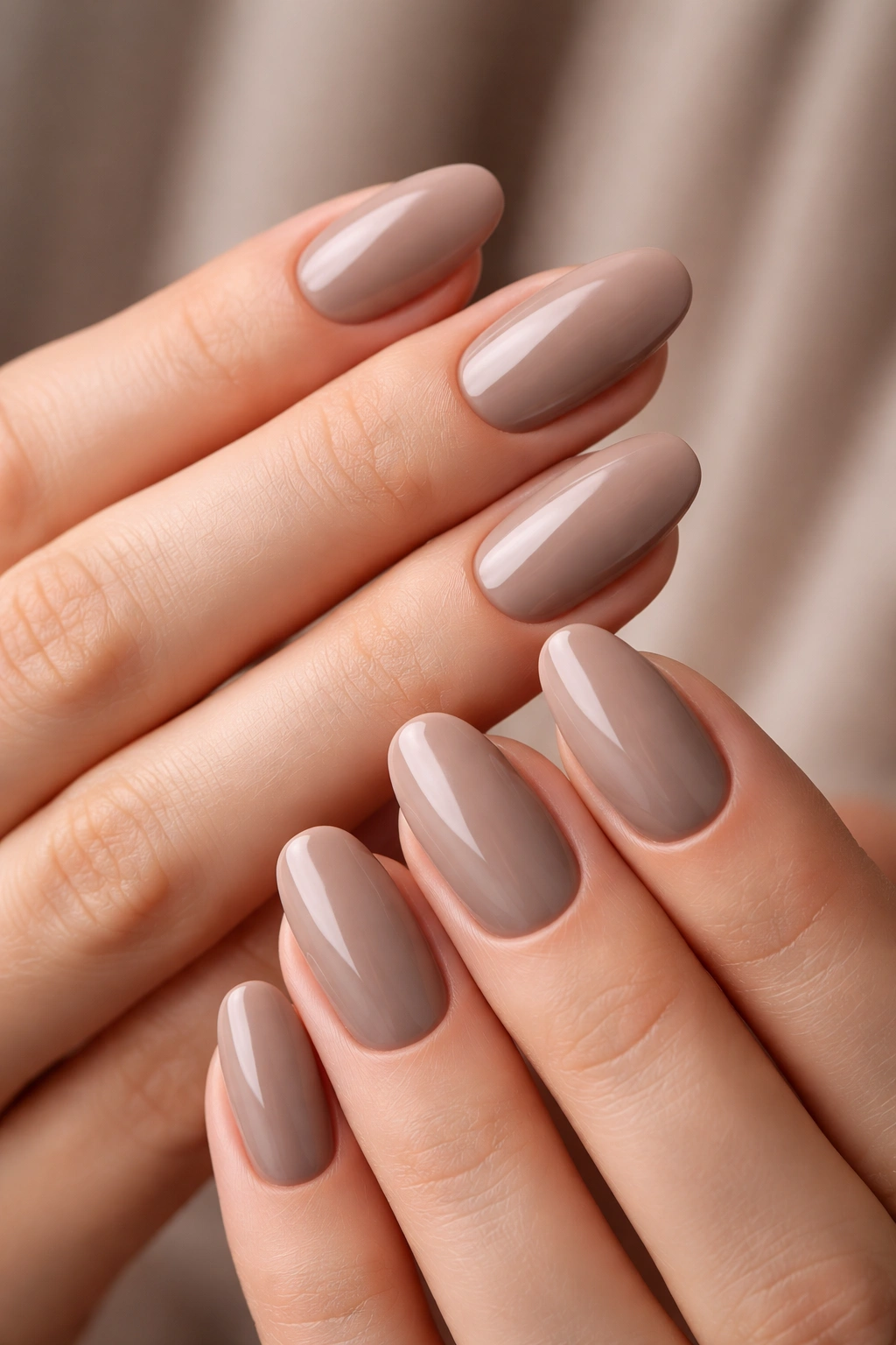 Close-up of taupe and greige nails with a satin finish on hands