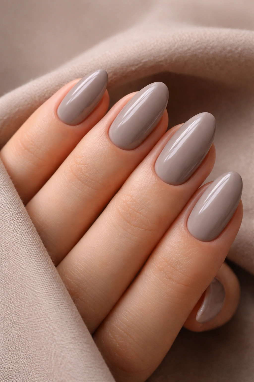 Short almond nails in cool taupe-grey polish