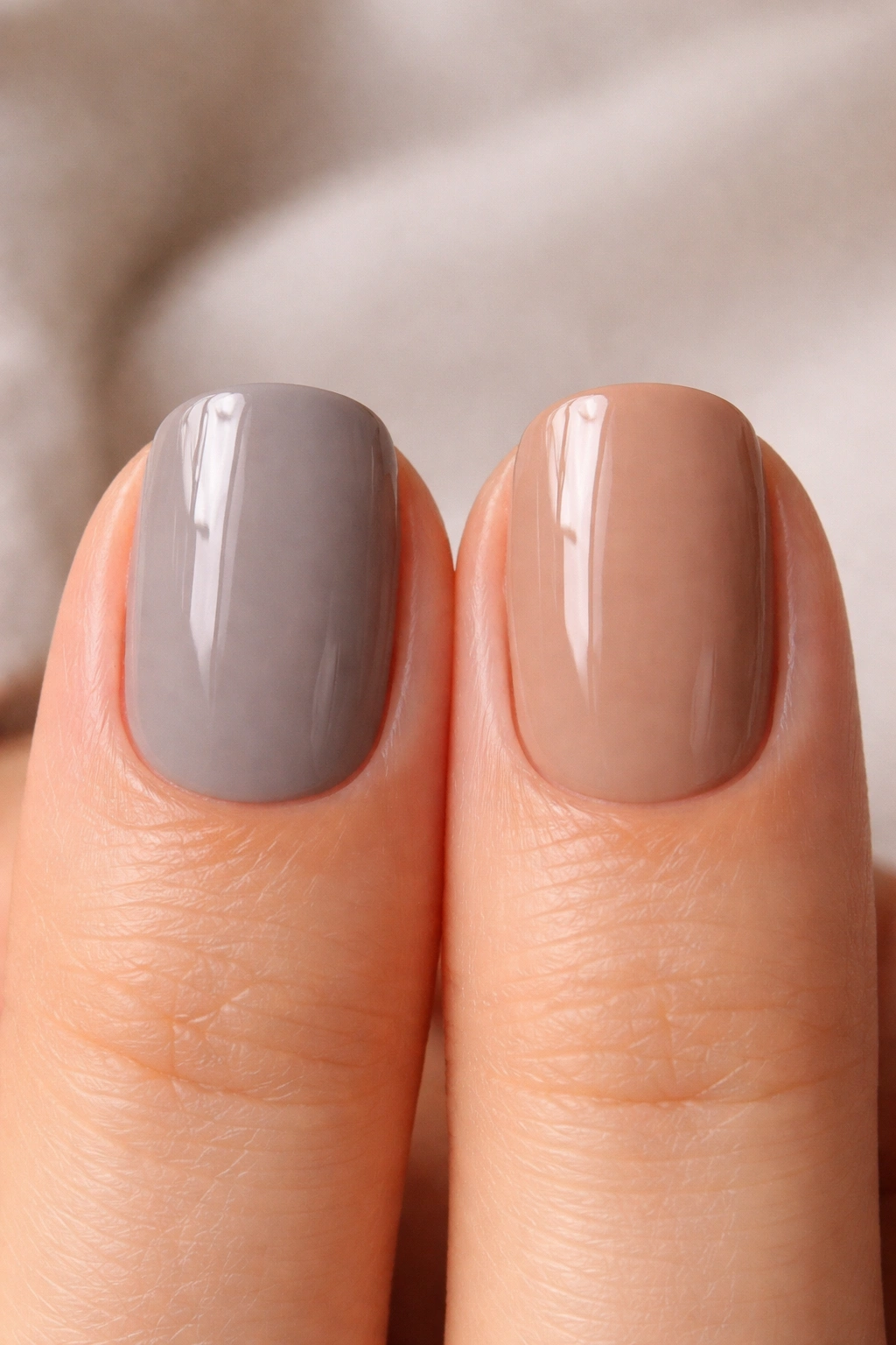 Two short squoval nails showing cool taupe and warm taupe contrast